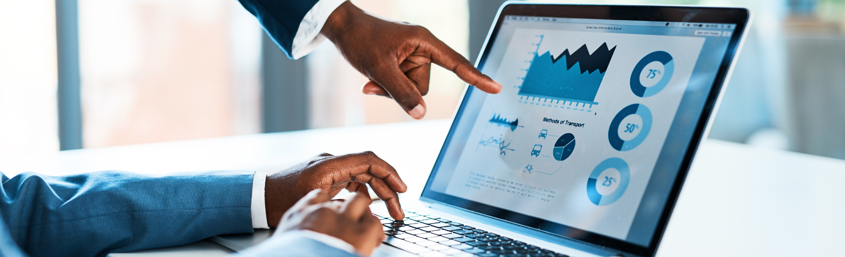 People pointing at data on a laptop.